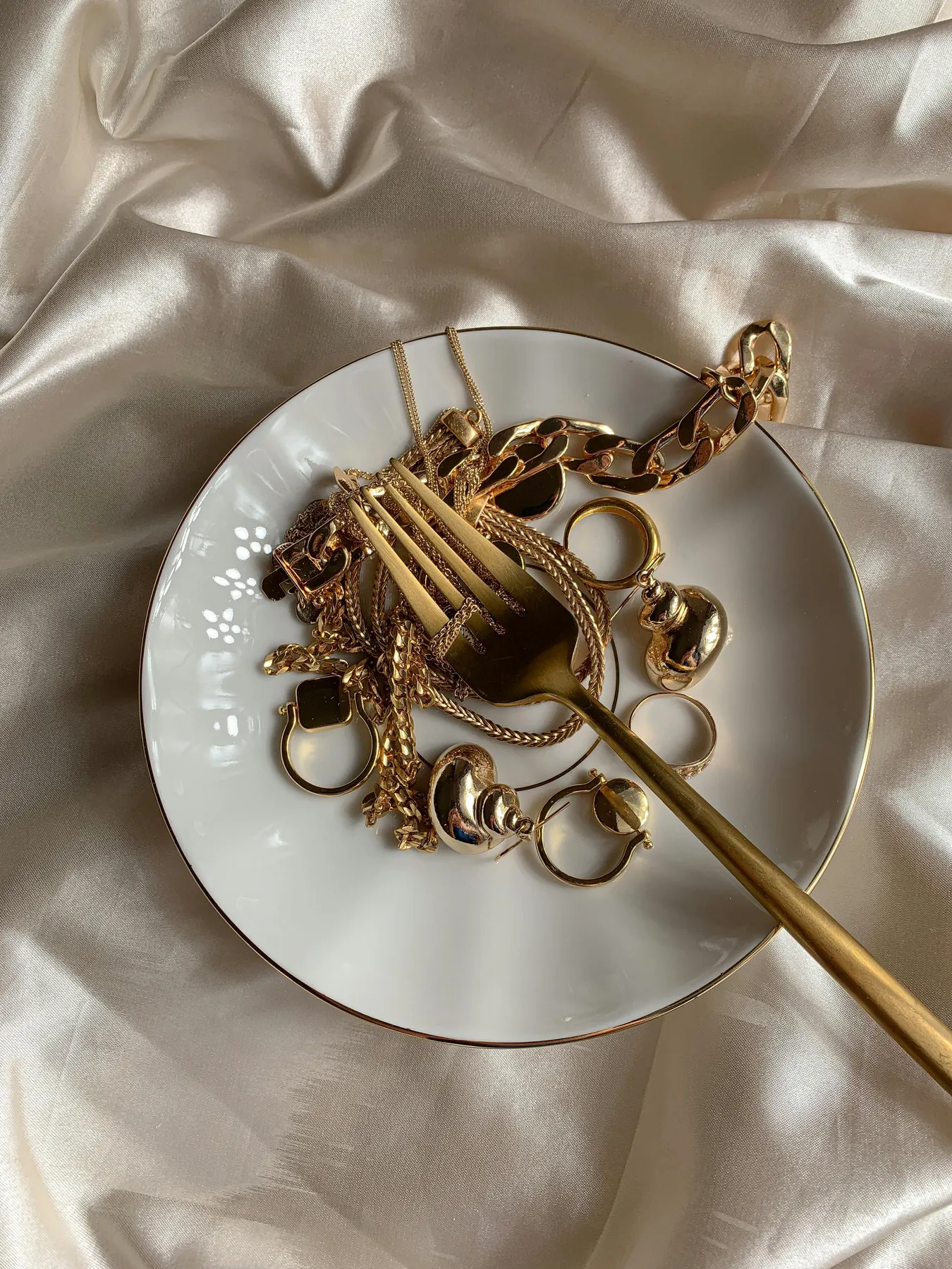 Gold jewelry arranged on silk in a private buying room
